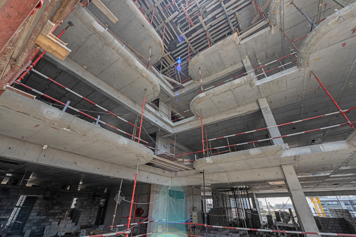 Pearl House By Imtiaz A construction site showing multiple concrete floors and scaffolding, illustrating ongoing building work.